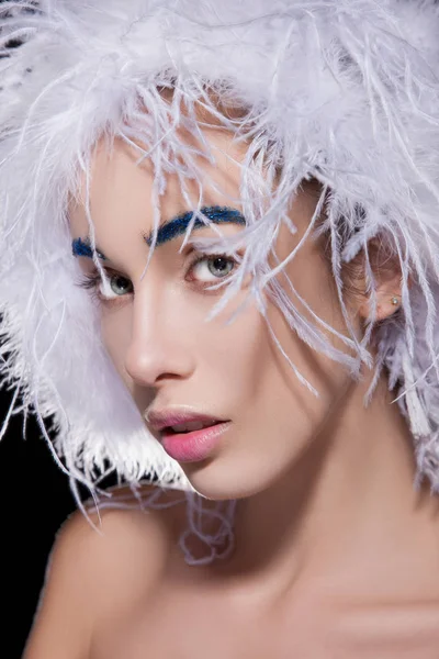 Woman in fluffy hat and blue eyebrows Royalty Free Stock Photos