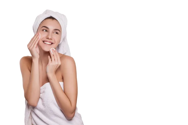 Cleansing the face skin. beautiful young woman cleans the face with cotton balls. spa. fresh healthy skin