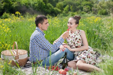 Boyfriend giving strawberry to girlfriend 