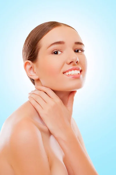 Smiling girl touching neck with hand — Stock Photo, Image
