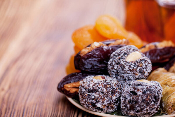 Arabian food. Sweets from dried fruits, Nuts and dried fruits, traditional black tea.