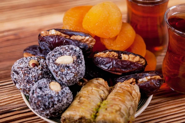 Arabian food. Sweets from dried fruits, Nuts and dried fruits, traditional black tea.