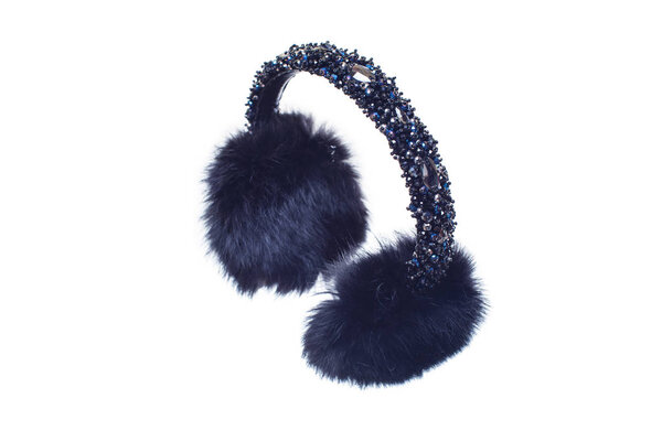 Winter headphones fur and stones on white background. Cozy and warm blue headphones.