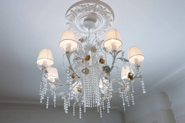 Beautiful Bronze Chandelier with Lighted Plafonds. Chandelier on Ceiling, Chandelier on chain with White Plafonds in Luxury House Interior