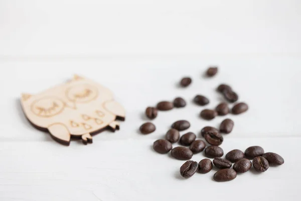 白い木製テーブル背景にフクロウ揚げコーヒー豆の山のクローズ アップ図します — ストック写真