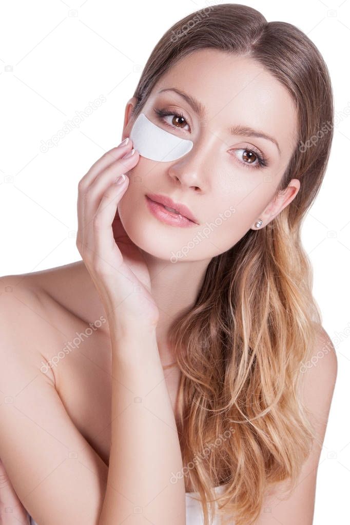 Closeup portrait of beauty model face with mask under eye, aesthetic facial. Care for skin under eye, medical care after blepharoplasty, eye mask