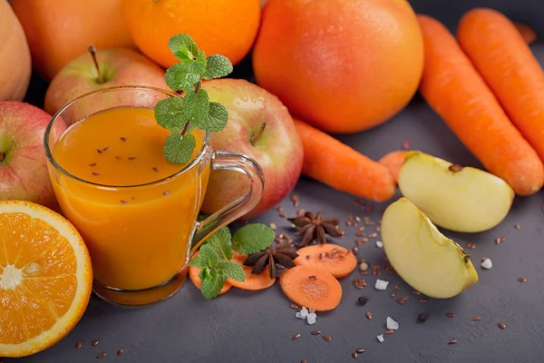 Fresh carrot, apple, pumpkin, orange, grapefruit on dark table. — Stock Photo, Image