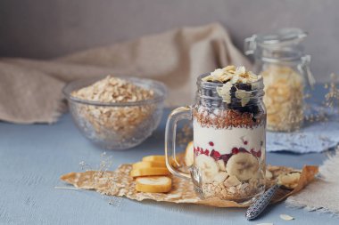 Katmanlı tatlı müsli, yoğurt, muz, keten tohumu, dilimlenmiş