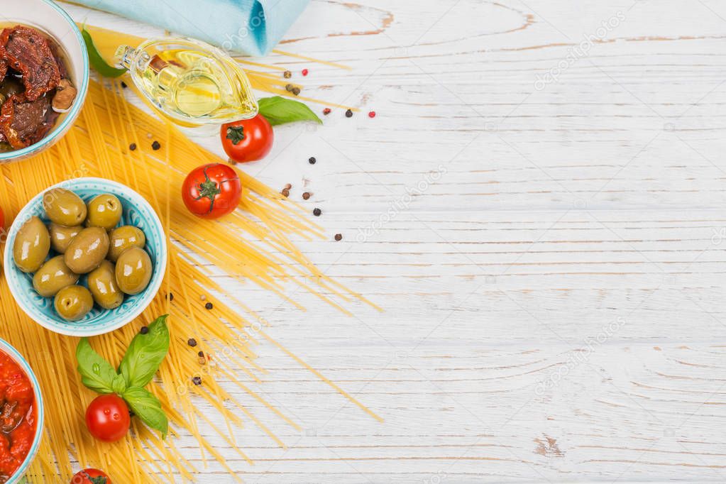 Ingredients for preparation pasta spaghetti - tomato, olive oil, spices, herbs, green olives, tomato sauce