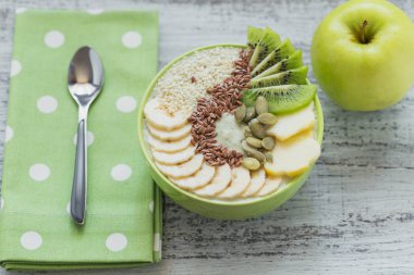 Yeşil smoothie kase kivi, muz, elma ve tohum f ile tepesinde