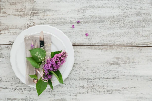 Rustic table setting with lilac flowers