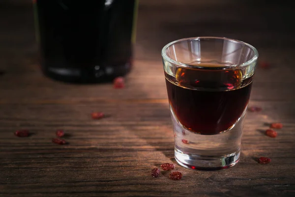 Herbal bitter liqueur with different natural ingredients. — Stock Photo, Image