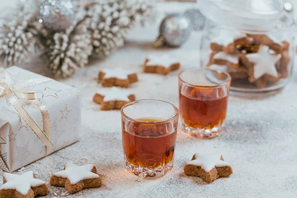 Whiskey, brandy or liquor, cookies and winter holiday decoration