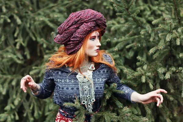 Extravagant redhead woman in ethnic national dress dancing or po — Stock Photo, Image