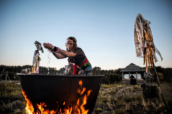 Witch brew a potion in the big cauldron — Stock Photo, Image