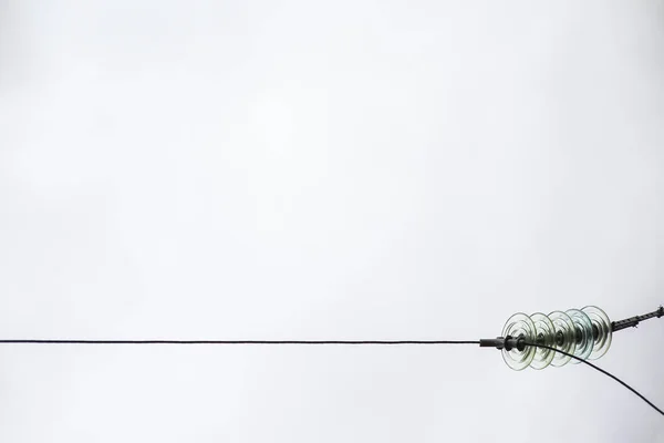 Γραμμή μεταφοράς ηλεκτρικής ενέργειας με διαφανή μονωτές. Φωτογραφημένο γκρο πλαν ενάντια στον ουρανό — Φωτογραφία Αρχείου