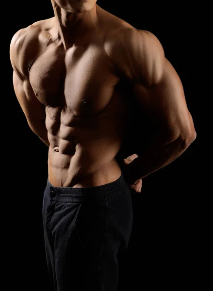 Muscular fitness man on black background — Stock Photo, Image