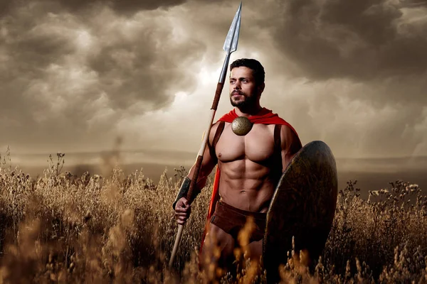 Soldier wearing in armor and loack like spartan. — Stock Photo, Image