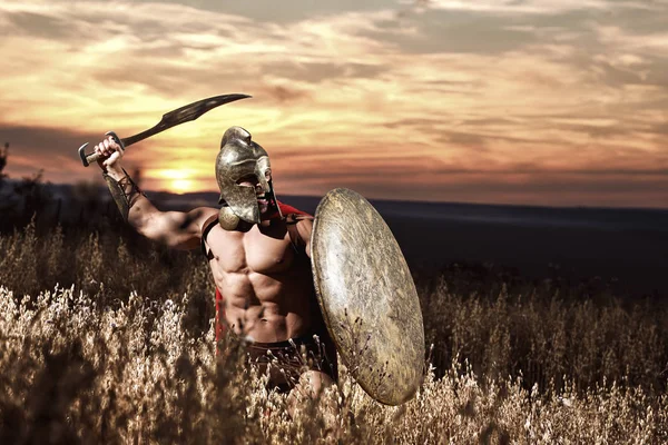 Warrior in helmet with bare torso going in attack. — Stock Photo, Image