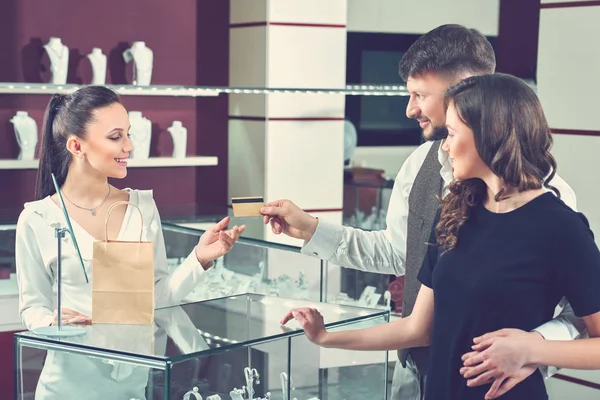 Щаслива пара закохалася в оплату кредитною карткою в ювелірному магазині — стокове фото
