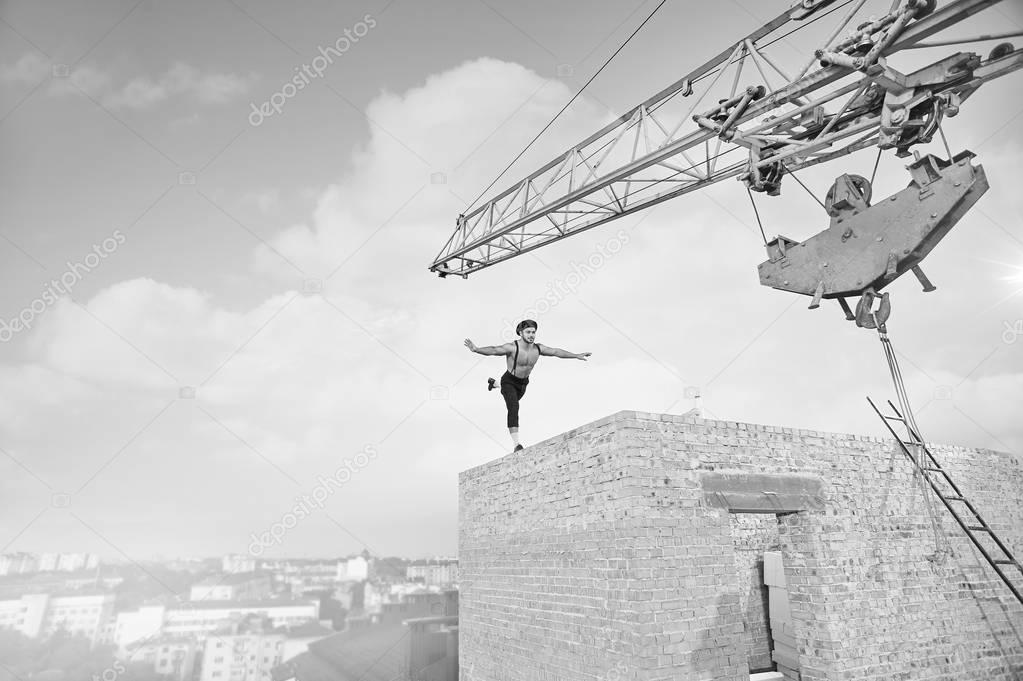 Vintage builder posing on top of a building under construction