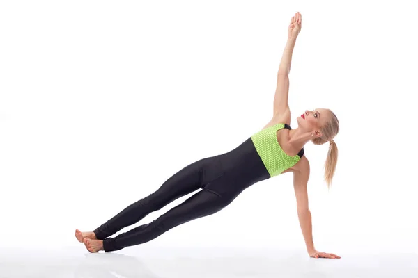 Attractive female gymnast exercising at studio — Stock Photo, Image