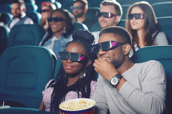 Couple of africans watching film in 3d glasses. — Stock Photo, Image