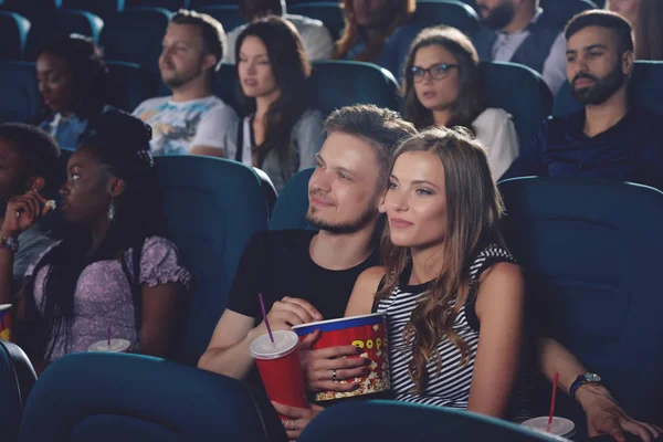 Couple embracing and looking at projector in cinema. — Stock Photo, Image