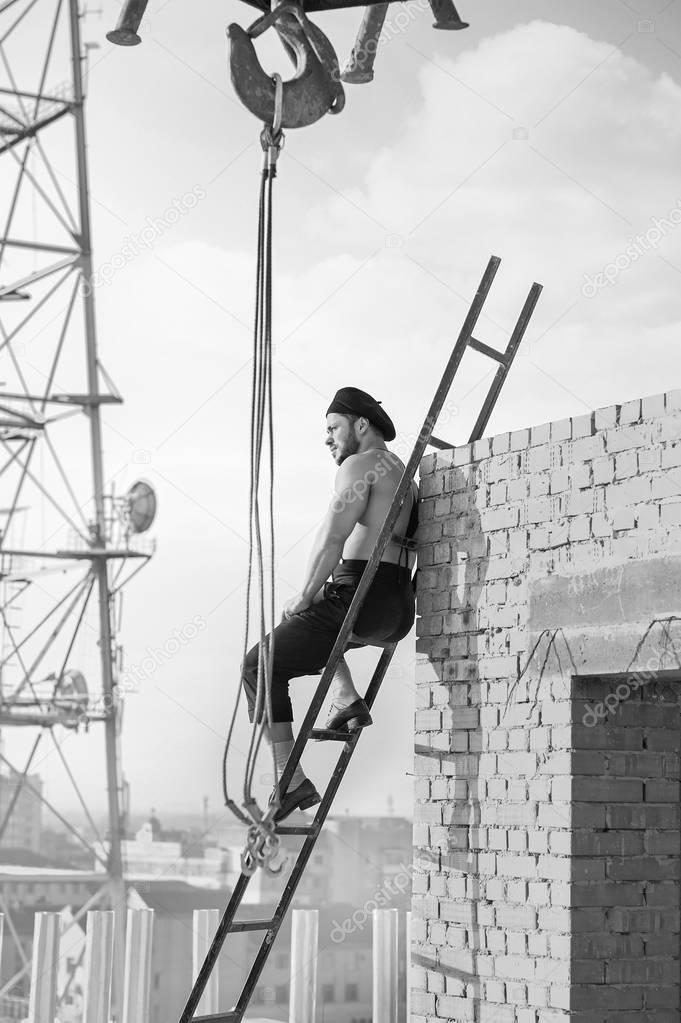 Retro construction worker climbing a ladder while working on the