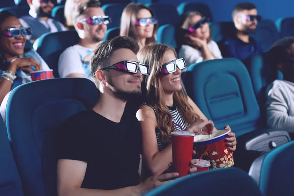 Positive couple drinking cola and eating popcorn in cinema. — Stock Photo, Image