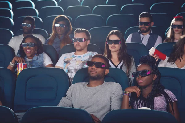 Africans and caucasians watching movie in 3d glasses. — Stock Photo, Image