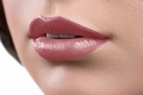 Close up shot of the lips of a woman wearing lipstick or lip glo