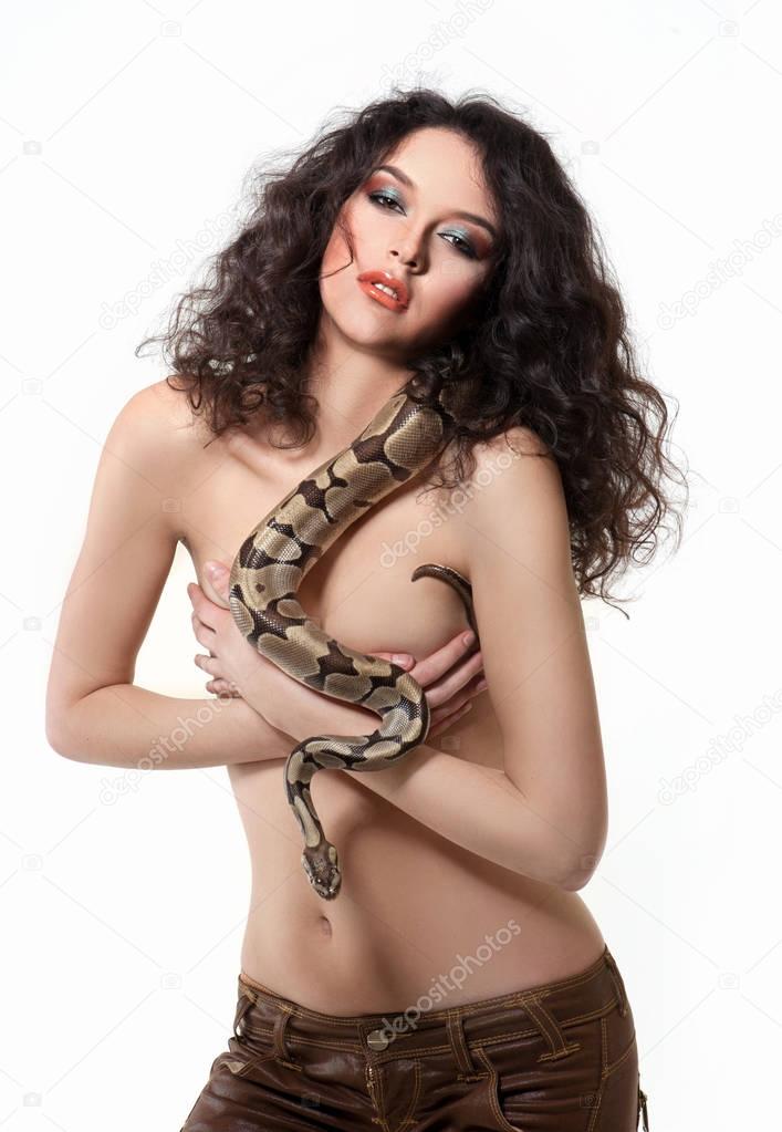 Sexy young dark hired woman posing topless holding a snake