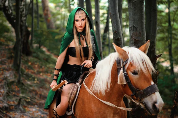 Female elf in the forest with her horse — Stock Photo, Image