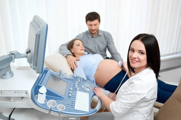 Junges verliebtes schwangeres Paar besucht gemeinsam Arzt — Stockfoto