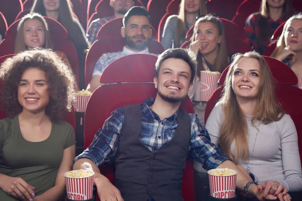 Three smiling best friends spending free time at cinema. — Stock Photo, Image