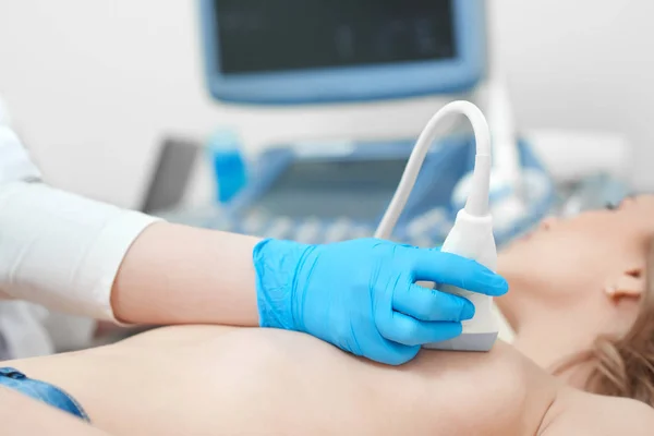 Young woman getting breast ultrasound scanning Stock Image