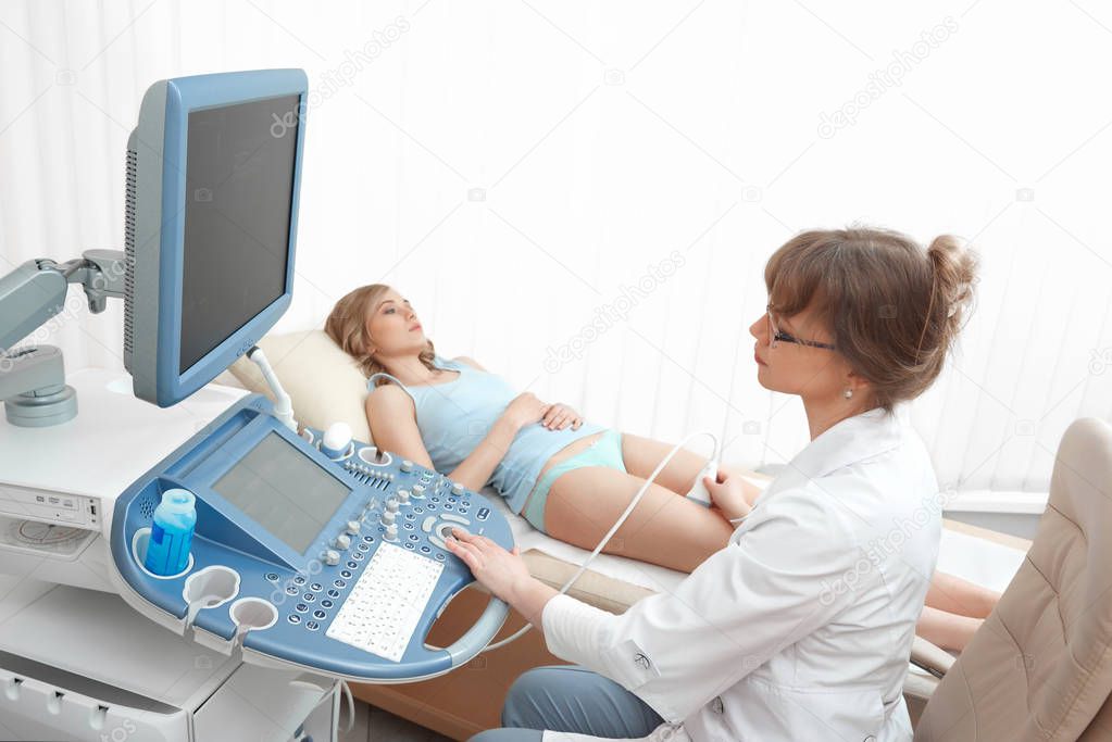 Woman getting knee ultrasound scanning examination at the clinic