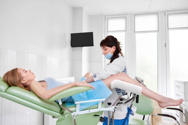 Professional gynecologist examining her patient Stock Image