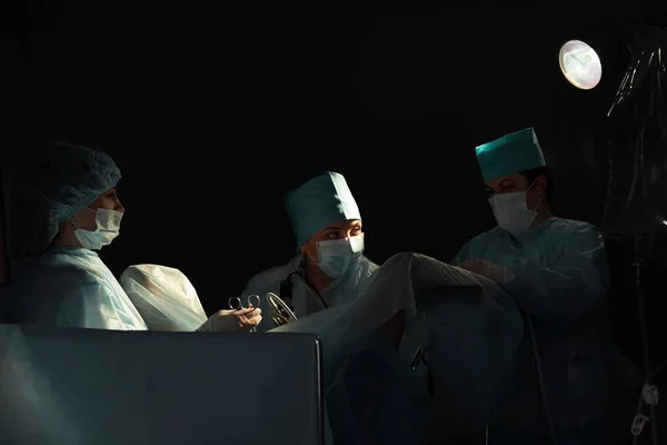 Team of surgeons performing operation