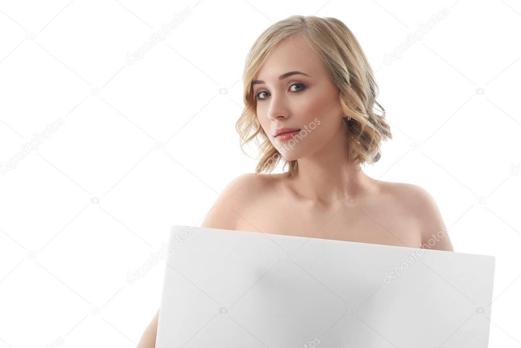Beautiful naked woman posing with a blank copyspace banner