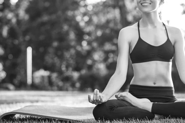 Jeune femme pratiquant le yoga en plein air au parc — Photo