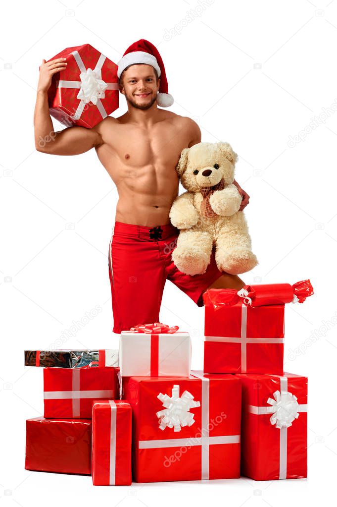 Handsome Santa Claus standing in a pile of presents