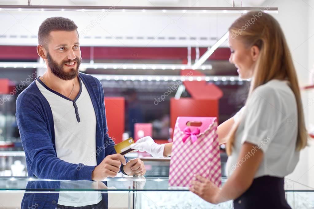 Young man shopping at the jewelry store