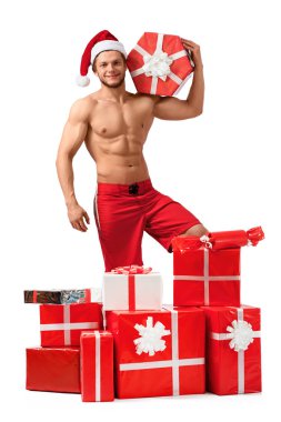 Yakışıklı Noel Baba hediyeleri yığını içinde ayakta