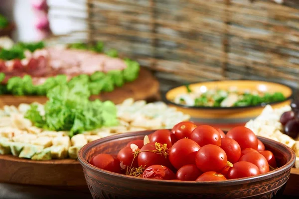 A fictile bowl full of marinated tomatoes — Stock Photo, Image
