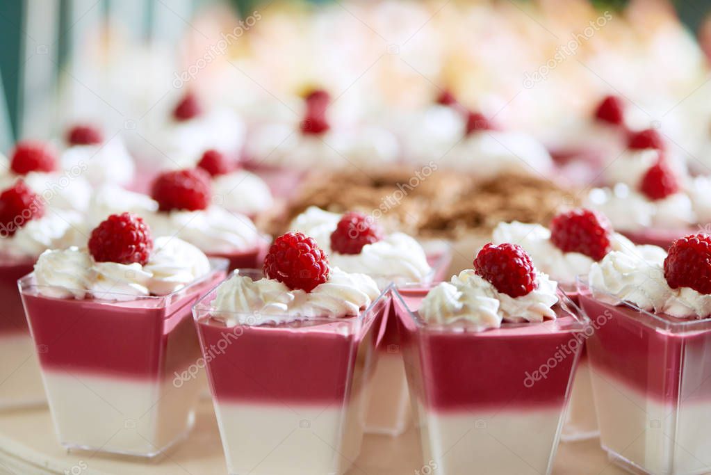 Sweet two-layer souffle with whipped cream and raspberry