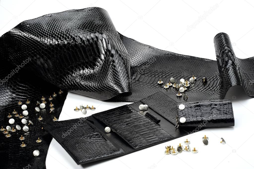 Black glancy pieces of leather look like reptile skin