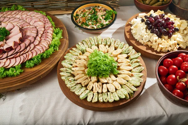 Restaurant table full of meat and vegetable appetizers — Stock Photo, Image