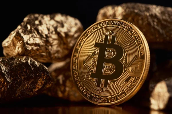 Golden bitcoin as main digital currency worldwide presented on black background with gold lamps — Stock Photo, Image